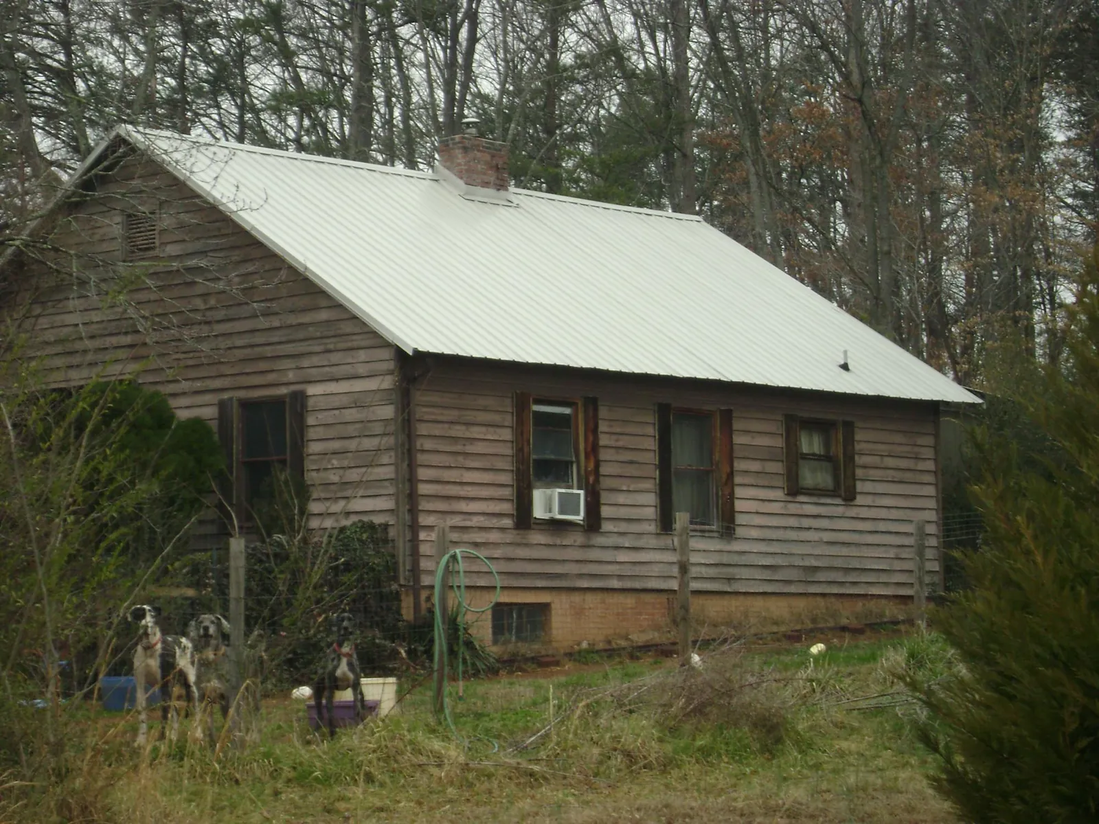 White metal roof on an old wood sided farmhouse, from a Metal Roof Installation job in Osseo